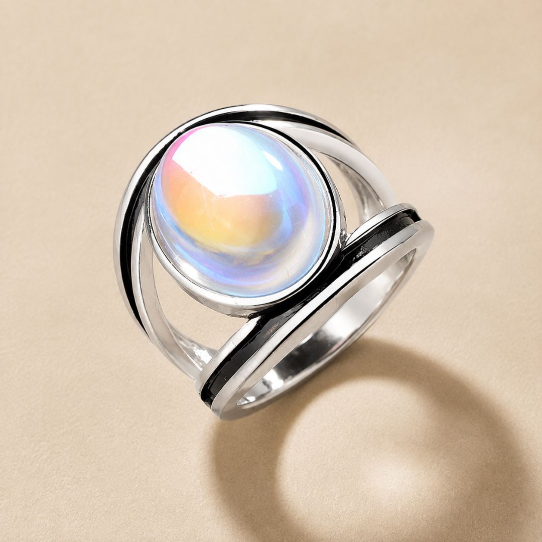 Avelune Moonstone Ring featuring an iridescent oval moonstone in a polished silver setting with black detailing