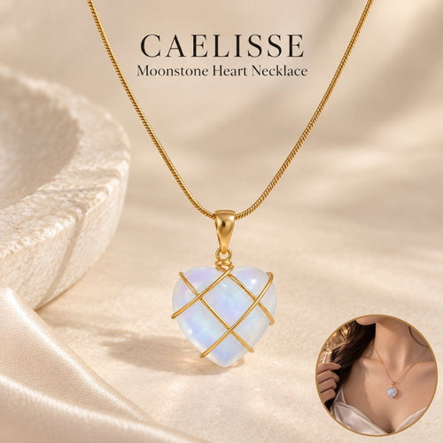 Caelisse Moonstone Heart Necklace with a translucent moonstone heart pendant, gold wire wrapping and delicate gold chain, presented in a warm ivory champagne setting.