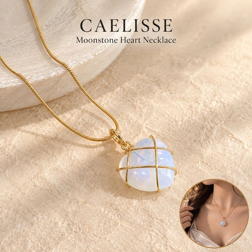 Caelisse Moonstone Heart Necklace featuring a translucent moonstone heart pendant with delicate gold wire wrapping and gold chain, shown in a warm ivory setting with a lifestyle view of the necklace worn.