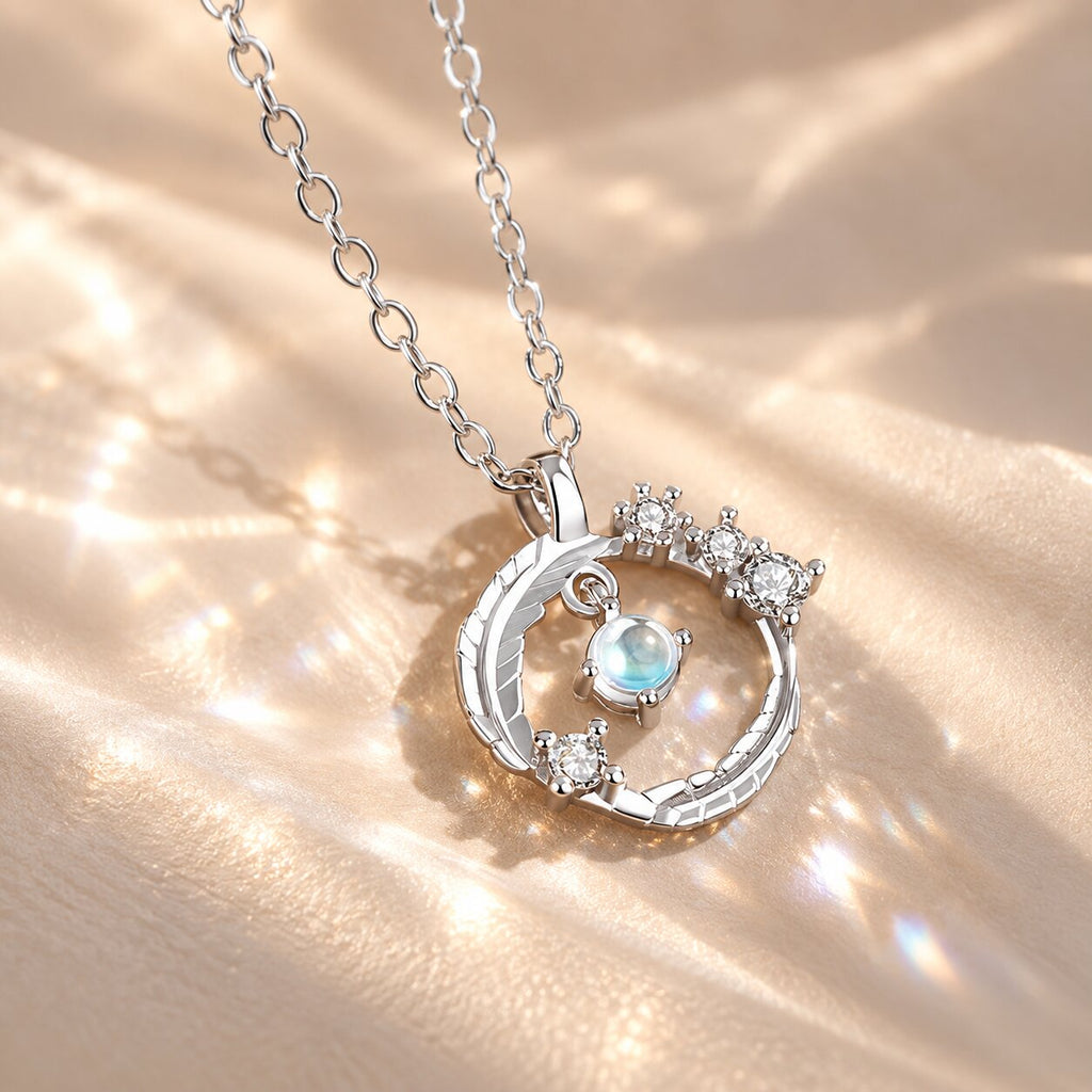 ELYRA Feather Moonstone Necklace close-up with luminous blue moonstone pendant and feather-inspired silver setting