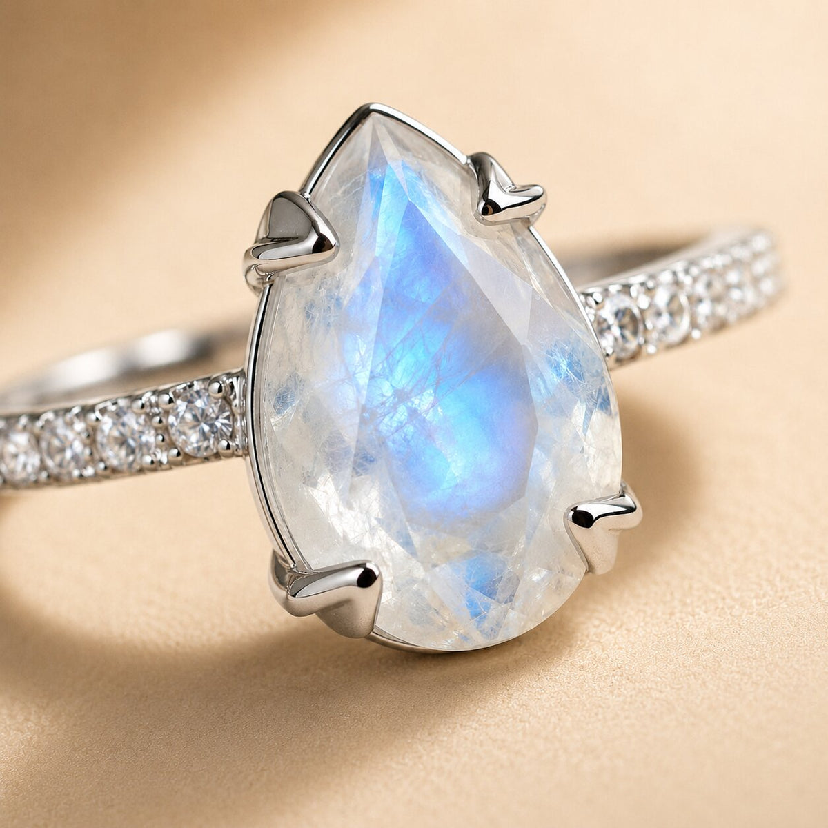 Lunelle pear-shaped moonstone ring with blue iridescent flashes and sparkling accent stones