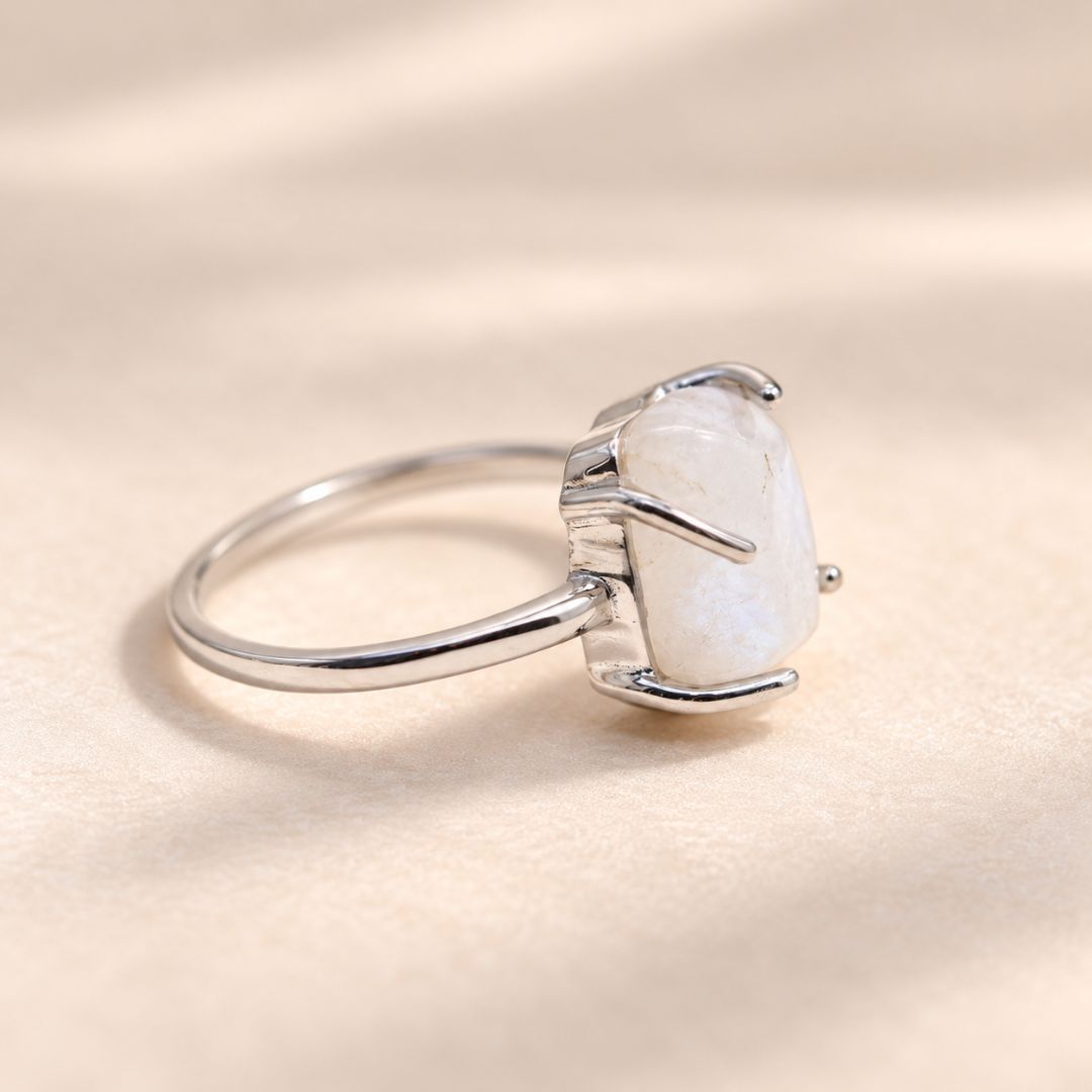 Serelle moonstone ring profile view showing the irregular moonstone, polished silver band, and four-prong setting