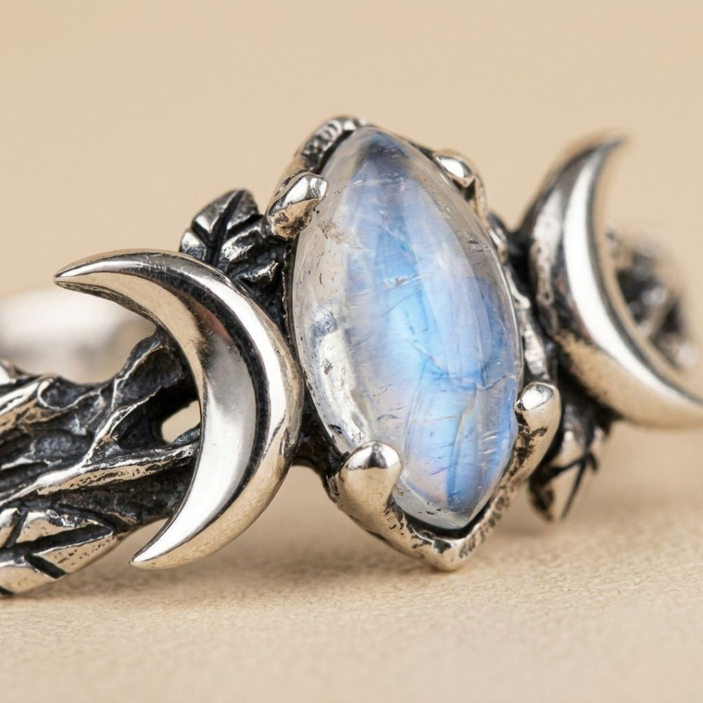 Veyra moonstone ring close-up showing the blue moonstone and polished crescent details